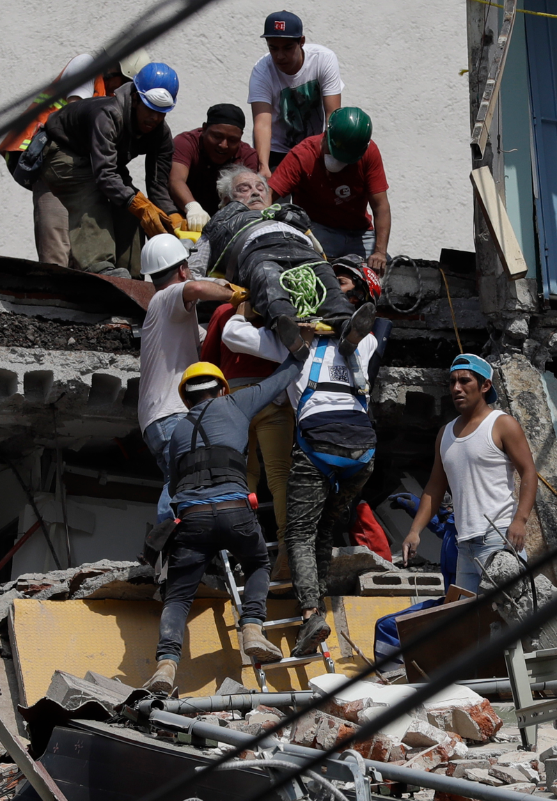 An injured man is pulled out of a building that collapsed during an earthquake in the Roma Norte neighborhood of Mexico City